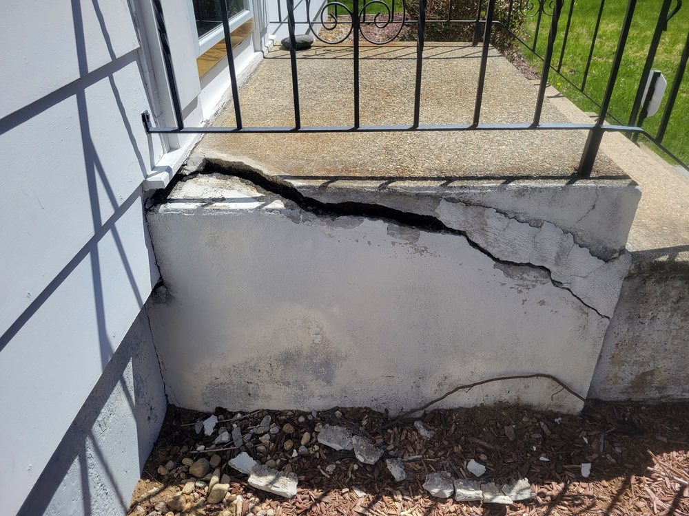 Cracked concrete steps outside a house
