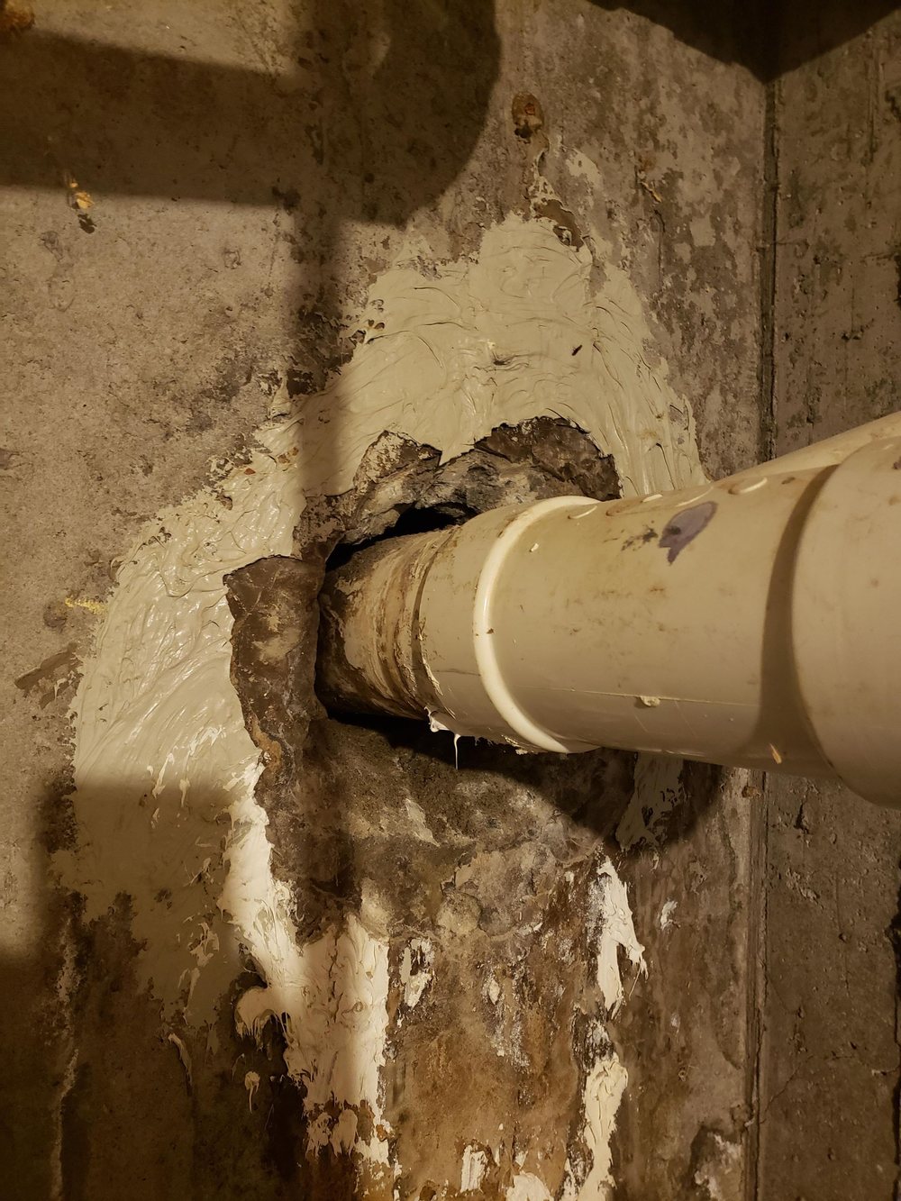 Pipe passing through a foundation wall