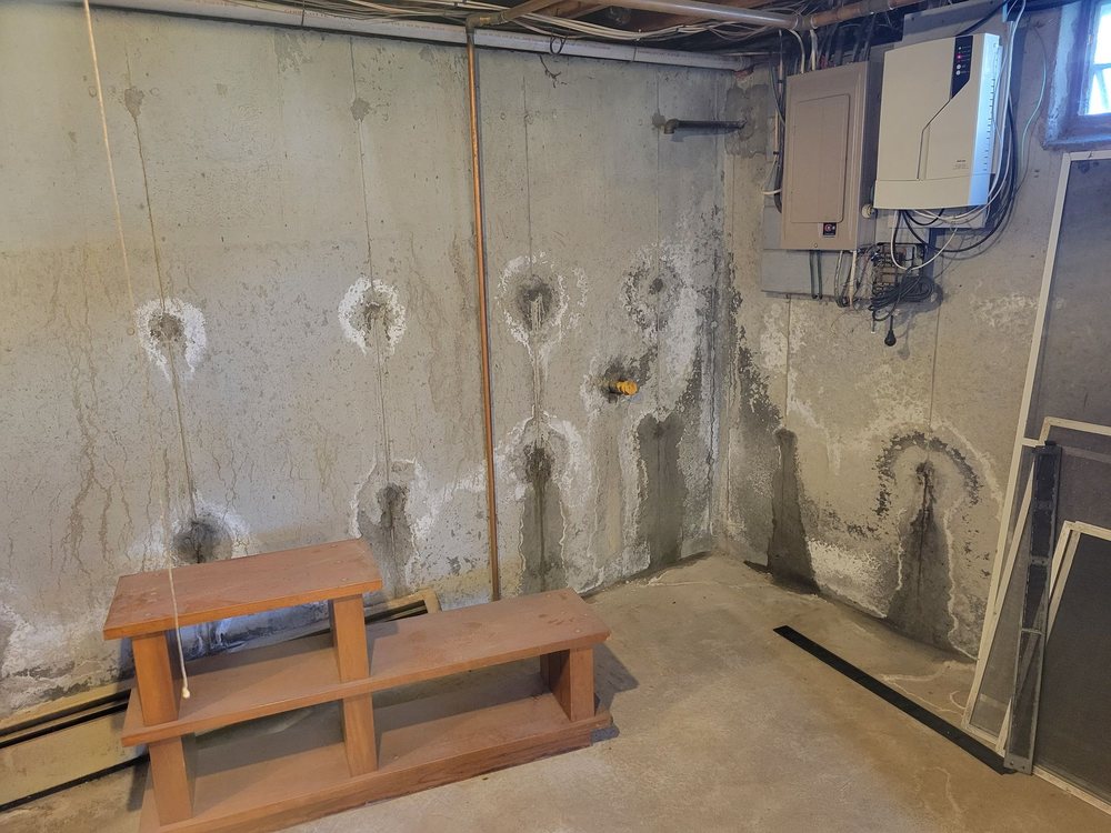 Leaking tie rod holes in a poured foundation wall